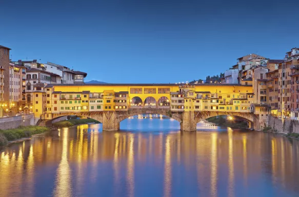 Panorama of Ponte Vecchio bridge and houses at twilight in Florence, Italy