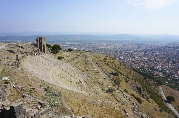 A steep hillside with rows of steps forming the ruins of the Theater of Pergamon, Turkey