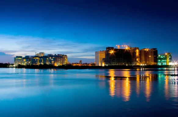 Night time shot of buildings on the edge of the water in Chennai