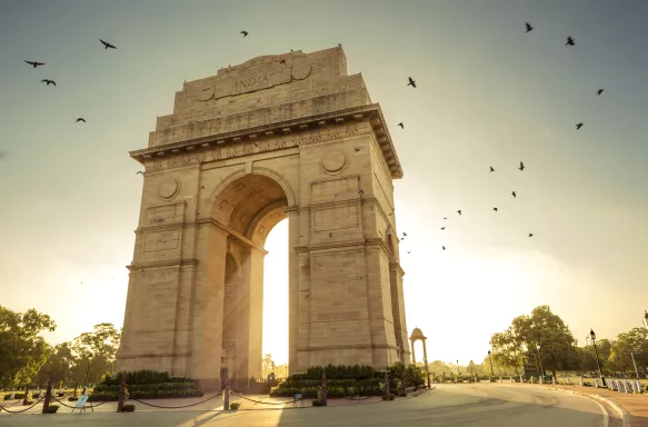 Sunrise over the India Gate, stone monument archway in New Delhi, India