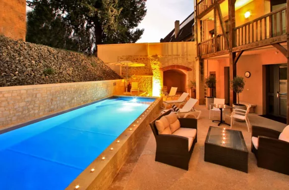Outdoor pool at Hotel le Compostelle during the evening in Sarlat, France