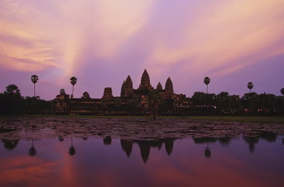 A distant view of Angkor Wat, a temple complex in Cambodia, at twilight