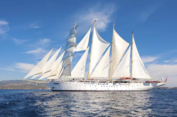 Exterior of the Star Clipper tall ship sailing under a blue sky