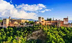 Landscape of Alhambra in Granada in Spain amid a beautiful green hilltop and blue skies