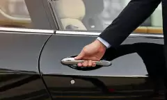 Close-up of concierge opening a private car door