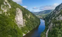 A large rock sculpture of decebalus overlooking the Danube River gorge 