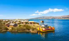 The floating islands on Titicaca Lake, featuring moored kayaks and wooden cabins