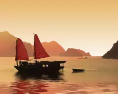 Junk boat at sunset in Halong Bay, Vietnam