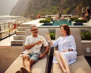 Two people cheers glasses on Sundeck