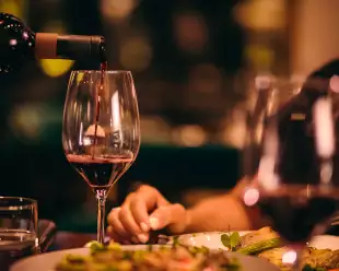 Close-up of red wine being served at fine dining restaurant