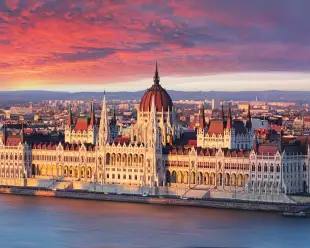 Aerial view of parliament building at dramatic sunrise in Budapest, Hungary