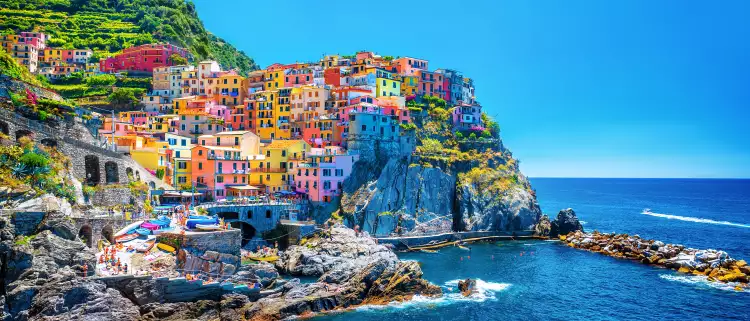 Colourful buildings along the cliffside of Cinque Terre over the Mediterranean sea