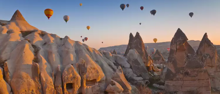 Hot air balloons rising up in the sky, in Cappadocia, Turkey.
