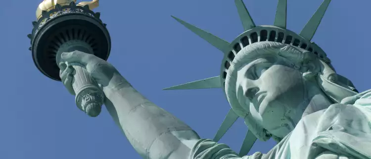 Close-up of the Statue of Liberty against a blue sky in New York