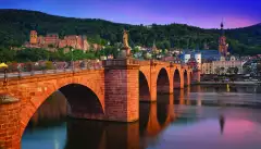 The old bridge in Heidelberg city and colourful evening sky in Germany