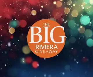 An orange circle with the words The Big Riviera Giveaway on it, with sparkling colours in the background