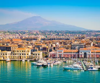 Beautiful view of Catania cruise port with smoking volcano Etna in the background