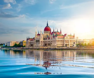 The Hungarian Parliament building over the Danube river at sunset in Budapest, Hungary