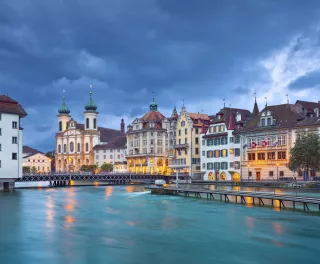 The Reuss River with surrounding buildings during a stormy evening in Lucerne, Switzerland