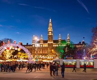 Christmas market with festive lights during the late evening in Rathausplatz square, Vienna, Austria