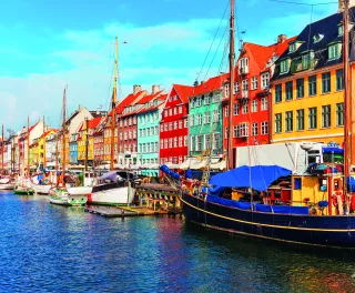 Nyhavn pier with colourful buildings, ships, yachts and other boats in the Old Town of Copenhagen, Denmark.