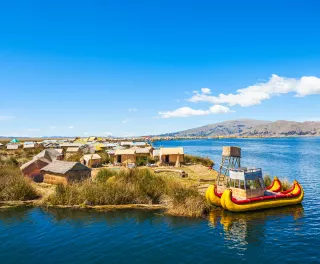 The floating islands on Titicaca Lake, featuring moored kayaks and wooden cabins