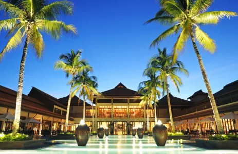 Exterior view of Furama Resort Danang with row of palm trees in Da Nang, Vietnam
