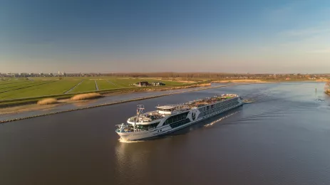 Distant side shot of the George Eliot, on a river